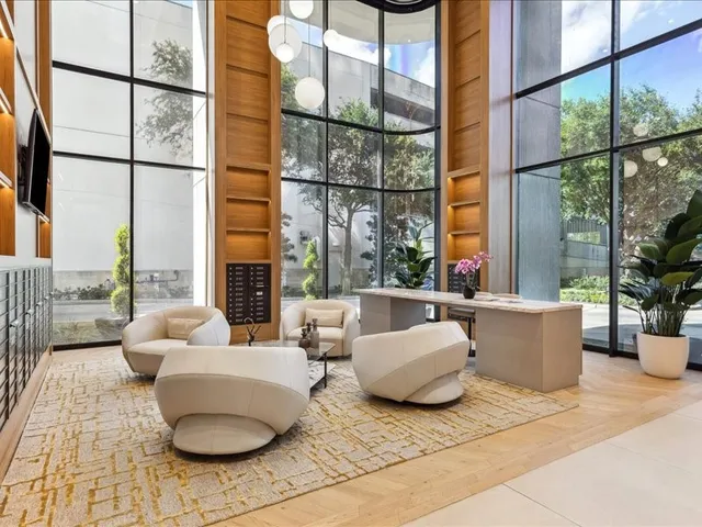 a living room with furniture and a floor to ceiling window