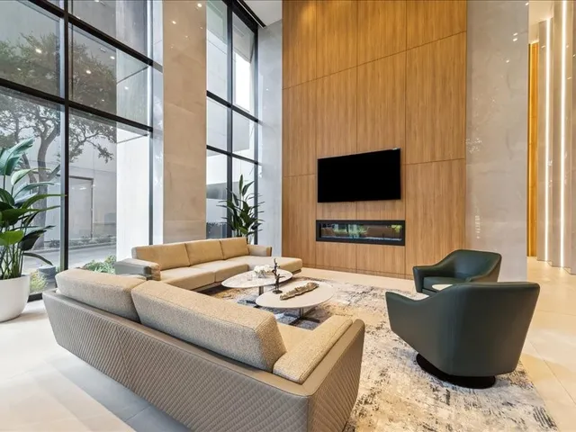 a living room with couches a coffee table and a flat screen tv