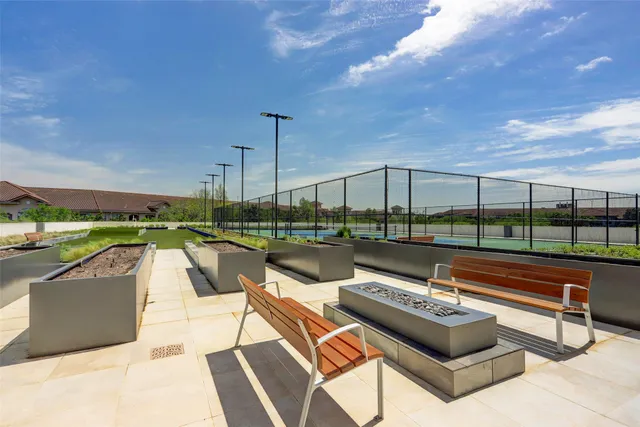 a view of swimming pool with outdoor seating and city view
