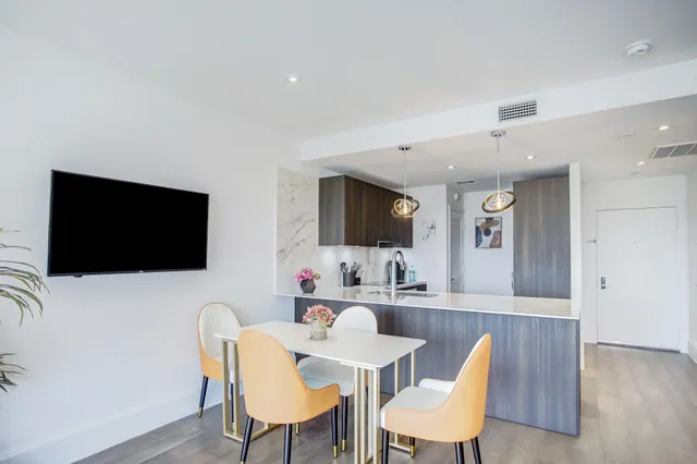 a view of a dining room with furniture and wooden floor
