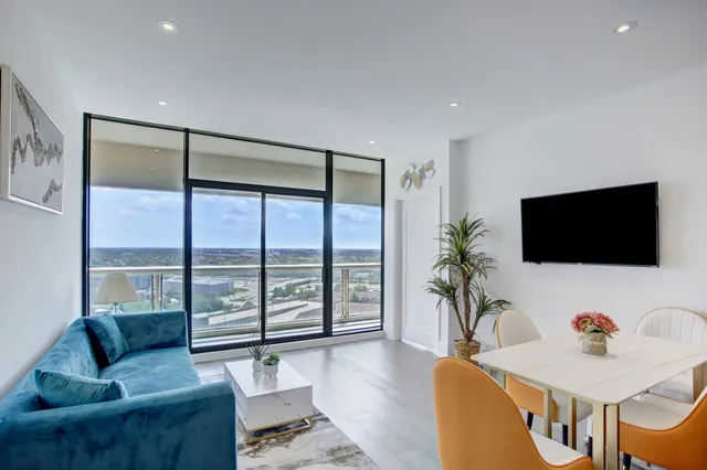 a living room with furniture tv and a large window