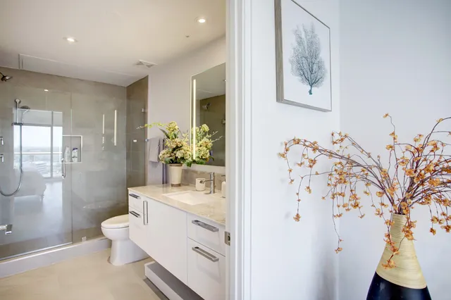 a bathroom with a sink toilet and shower