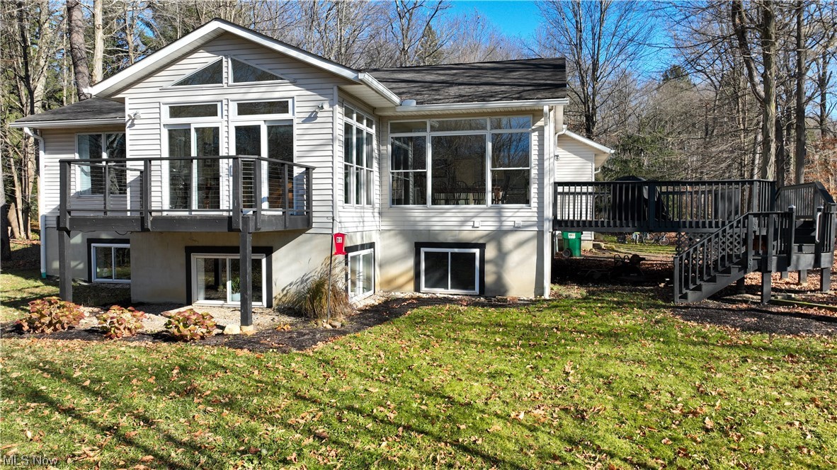 Rear view of property featuring a yard
