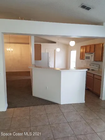 a kitchen with a stove top oven a refrigerator and a stove