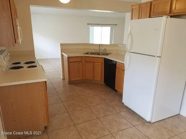a kitchen with cabinets and white appliances