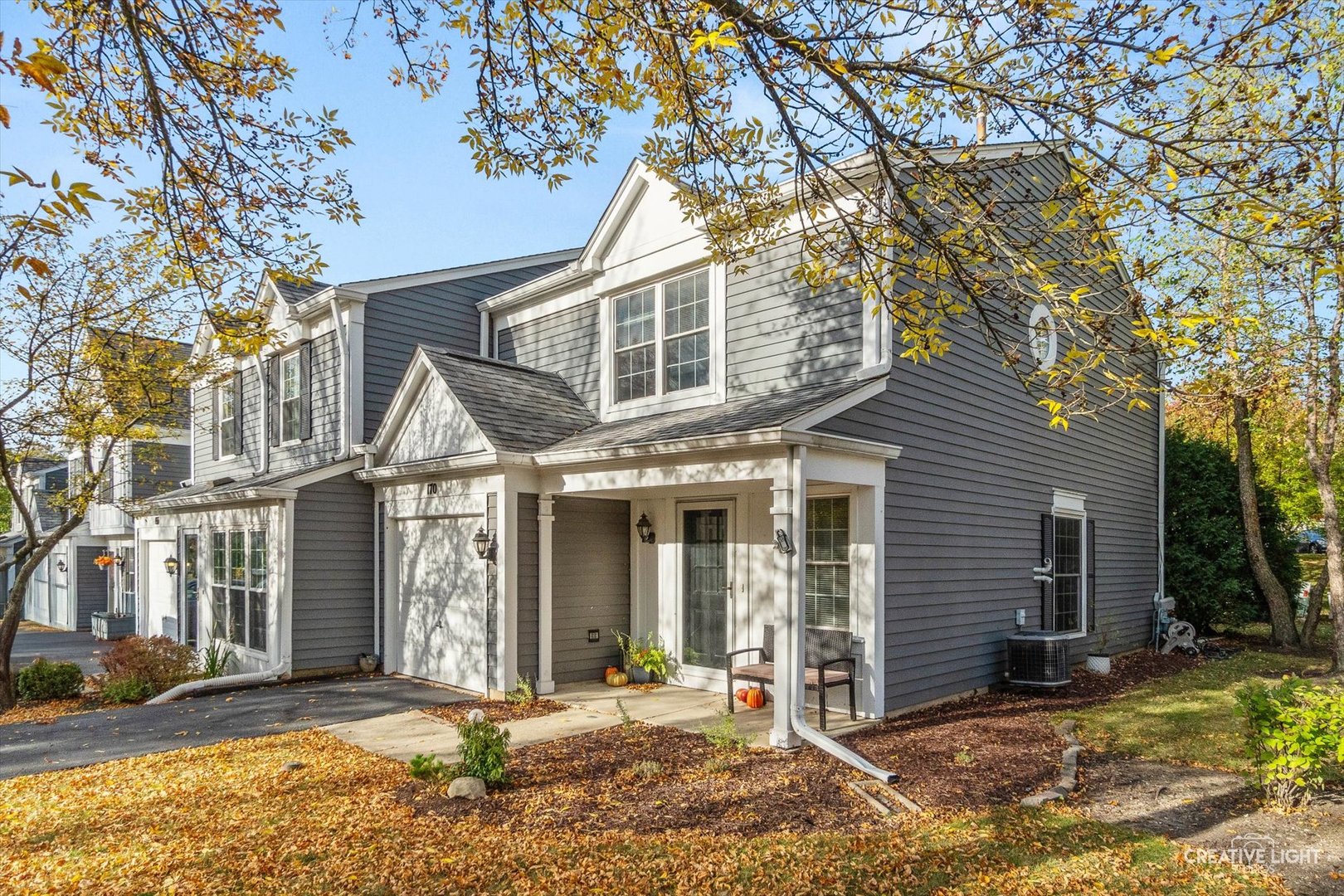 170 Half Moon Circle Aurora, IL 60504 - Photo 1 of 15 a view of a white house with large windows and a tree