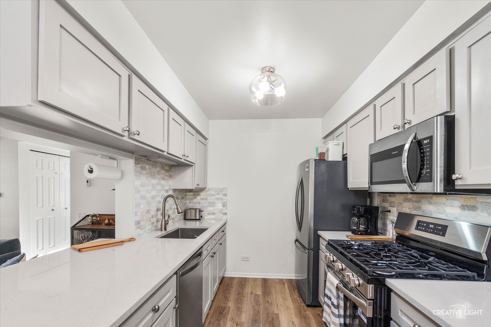 170 Half Moon Circle Aurora, IL 60504 - Photo 7 of 15 a kitchen with stainless steel appliances granite countertop a stove refrigerator sink and microwave