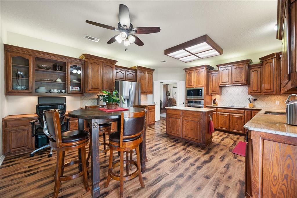 413 Rugged Drive Red Oak, TX 75154 - Photo 12 of 39 The breakfast area has a built in desk area that could be your coffee bar with open cabinets