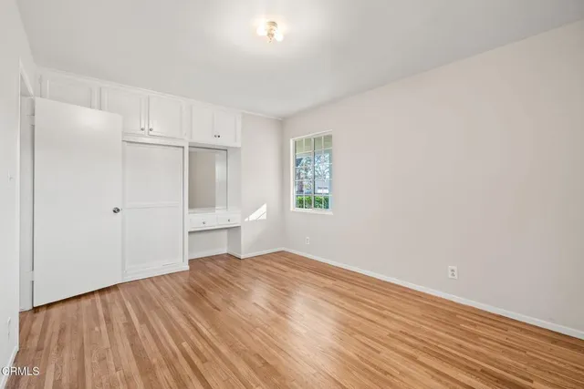 a view of a room with wooden floor and windows