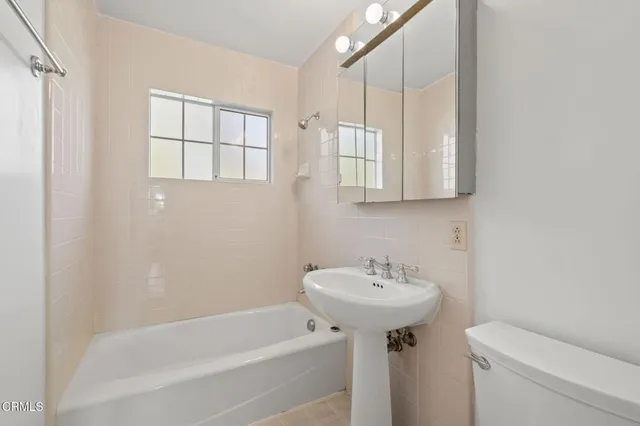 a bathroom with a sink a toilet and a bathtub