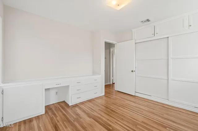 a view of a room with wooden floor