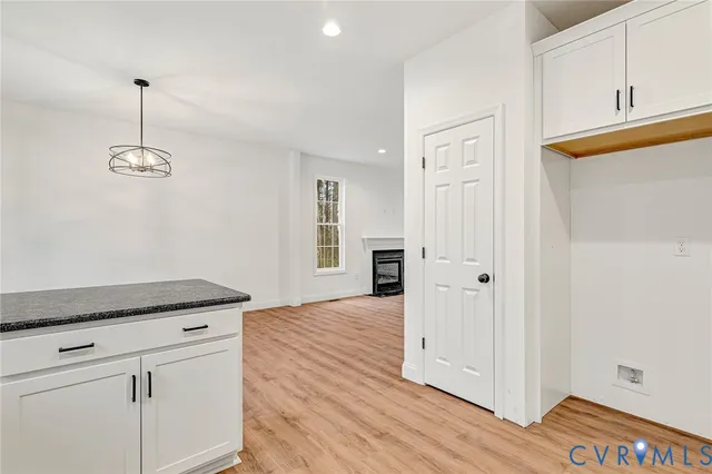 a kitchen with granite countertop cabinets and wooden floor