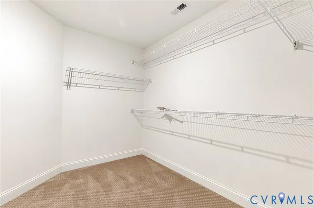 an empty room with a ceiling fan and a window