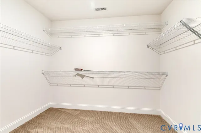 an empty room with closet and windows