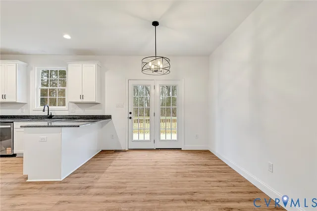 a view of a kitchen with granite countertop wooden floor and a window