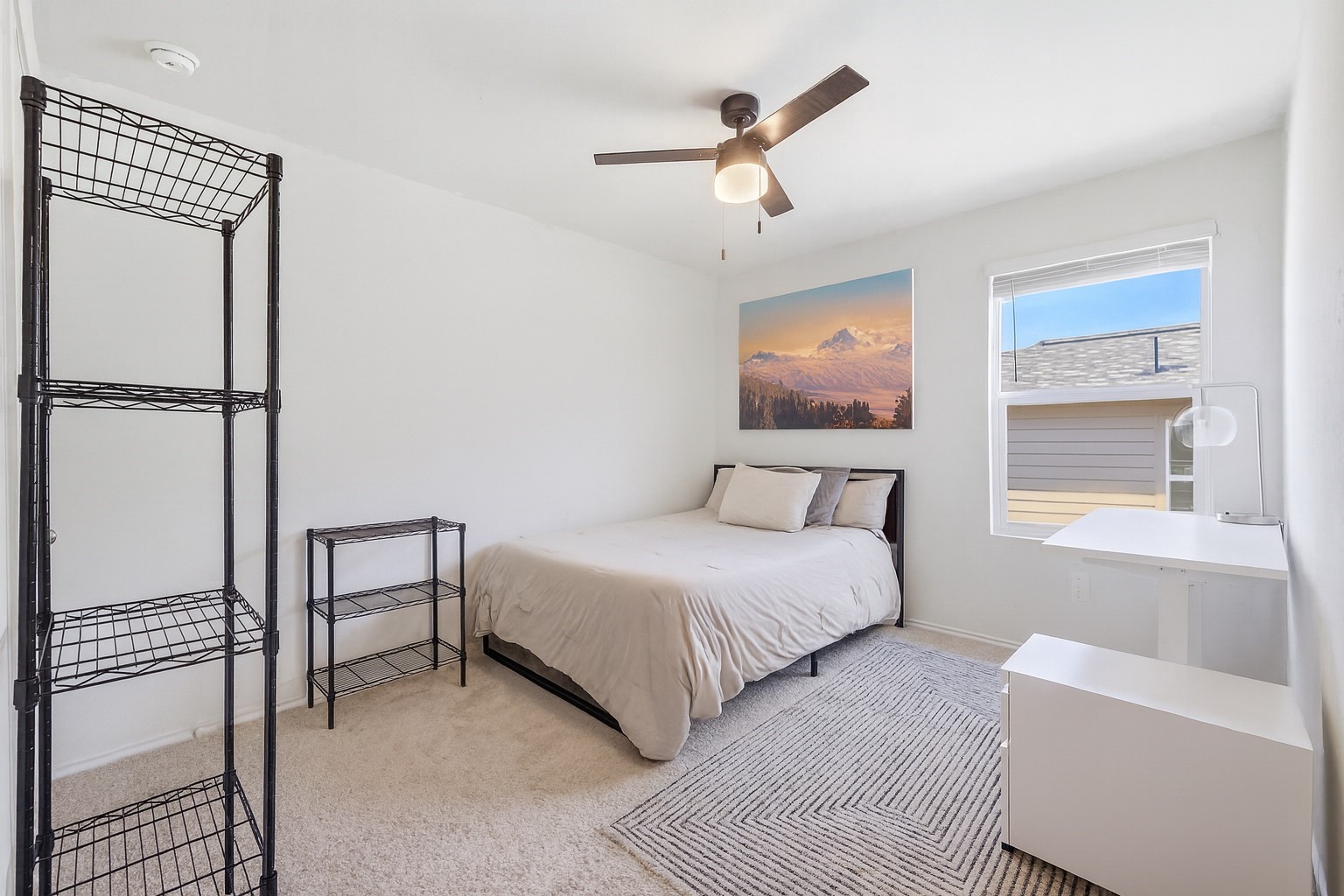 15000 Bajada Rd Manor Manor, TX 78653 - Photo 24 of 31 A well-lit bedroom provides comfortable living space with a ceiling fan and ample natural light.