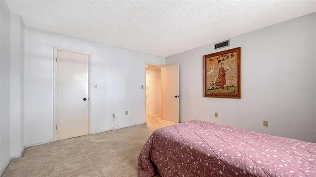 a view of swimming pool with palm trees