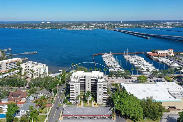 a bedroom with a bed a couch and a dresser next to a window