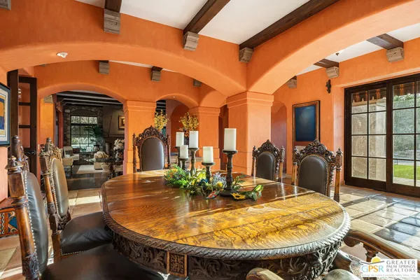 a view of a dining room with furniture and a chandelier