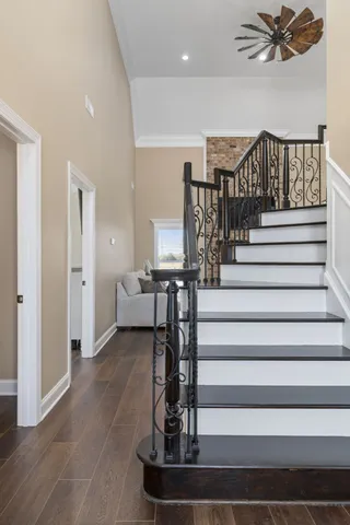a view of entryway and hall with wooden floor