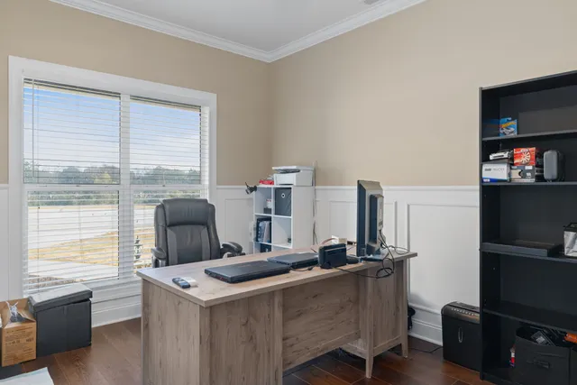 a room with furniture a flat screen computer and a window