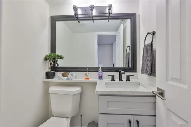 a kitchen with white cabinets and appliances