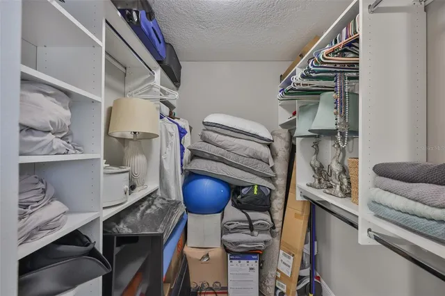 a view of a livingroom with wooden floor and a ceiling fan