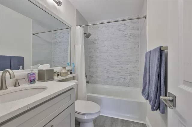 a view of a hallway with closet and a fireplace