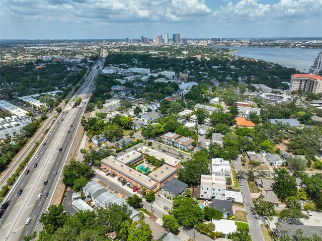 a view of a house with a yard and street