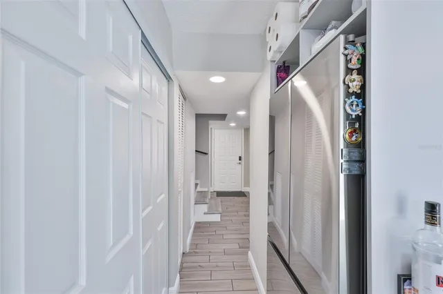 a kitchen with white cabinets and sink