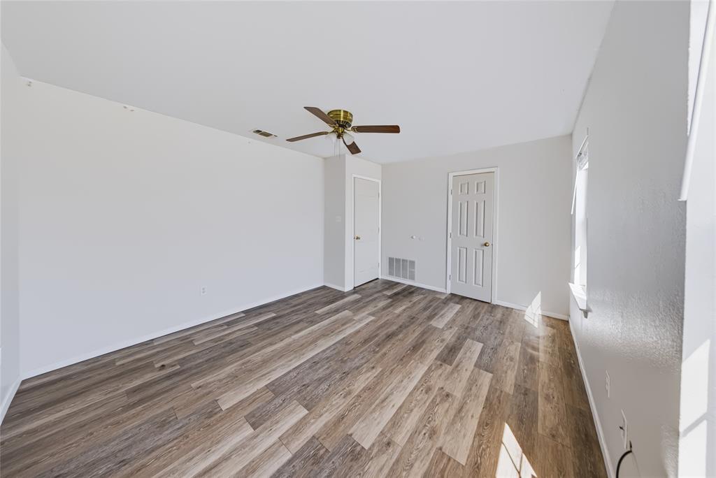 560 Green Acres Road Weatherford, TX 76088 - Photo 9 of 35 Main Home – Spacious interior with wood-finish flooring, ceiling fan, and crisp white walls