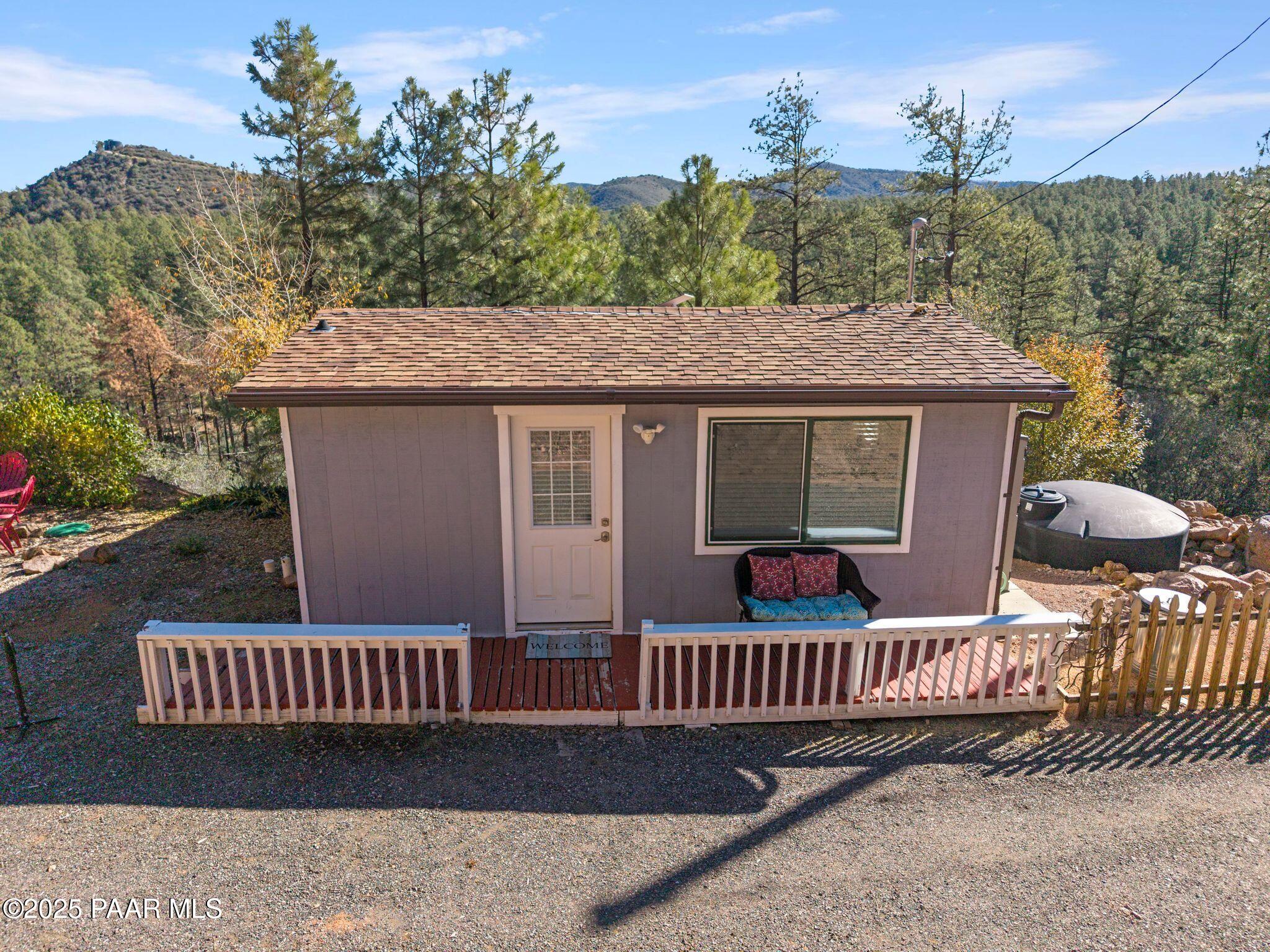 1420 White Spar Road Prescott, AZ 86303 - Photo 1 of 24 a view of a deck with a table and chairs with wooden fence
