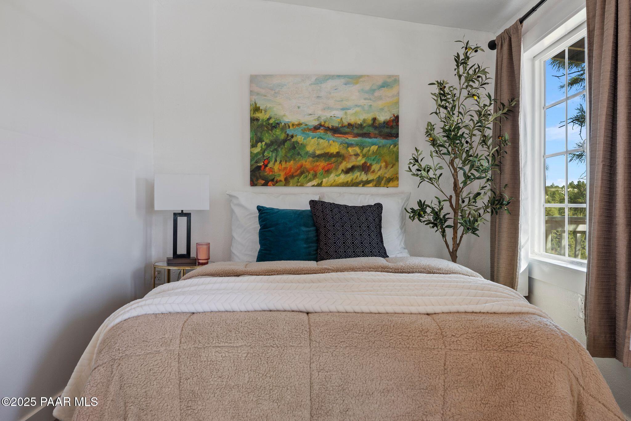 1420 White Spar Road Prescott, AZ 86303 - Photo 14 of 24 a large bed sitting in a bedroom next to a window