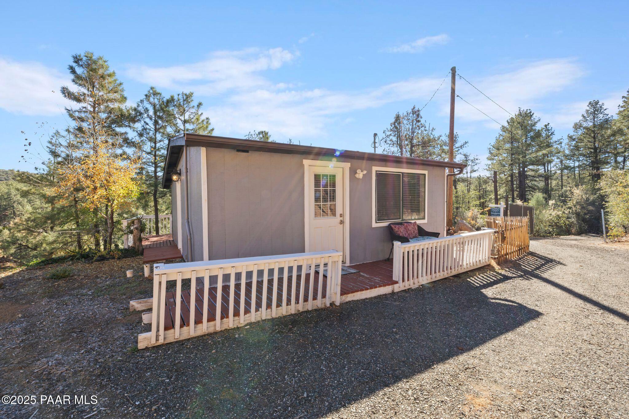 1420 White Spar Road Prescott, AZ 86303 - Photo 3 of 24 a view of a house with a wooden deck and a floor to ceiling window