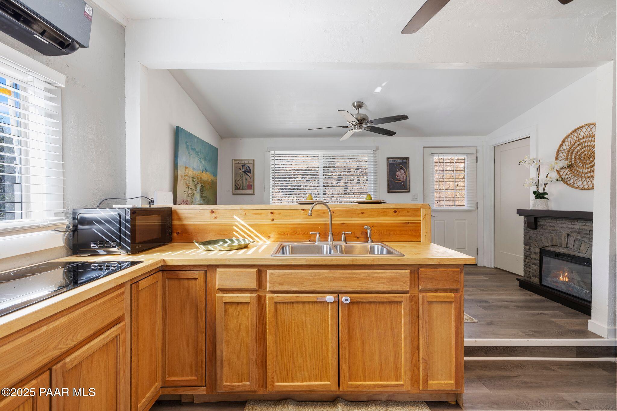 1420 White Spar Road Prescott, AZ 86303 - Photo 8 of 24 a view of a kitchen with kitchen island stainless steel appliances wooden floor and large windows