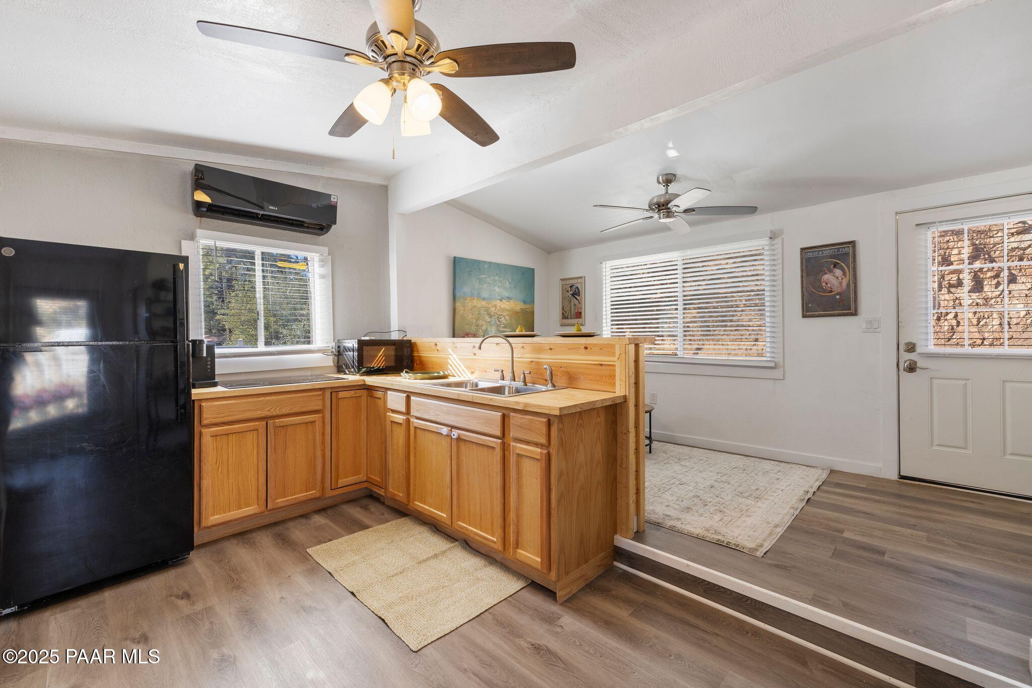 1420 White Spar Road Prescott, AZ 86303 - Photo 9 of 24 a kitchen with stainless steel appliances granite countertop a refrigerator a sink dishwasher a stove with wooden cabinets and dining table