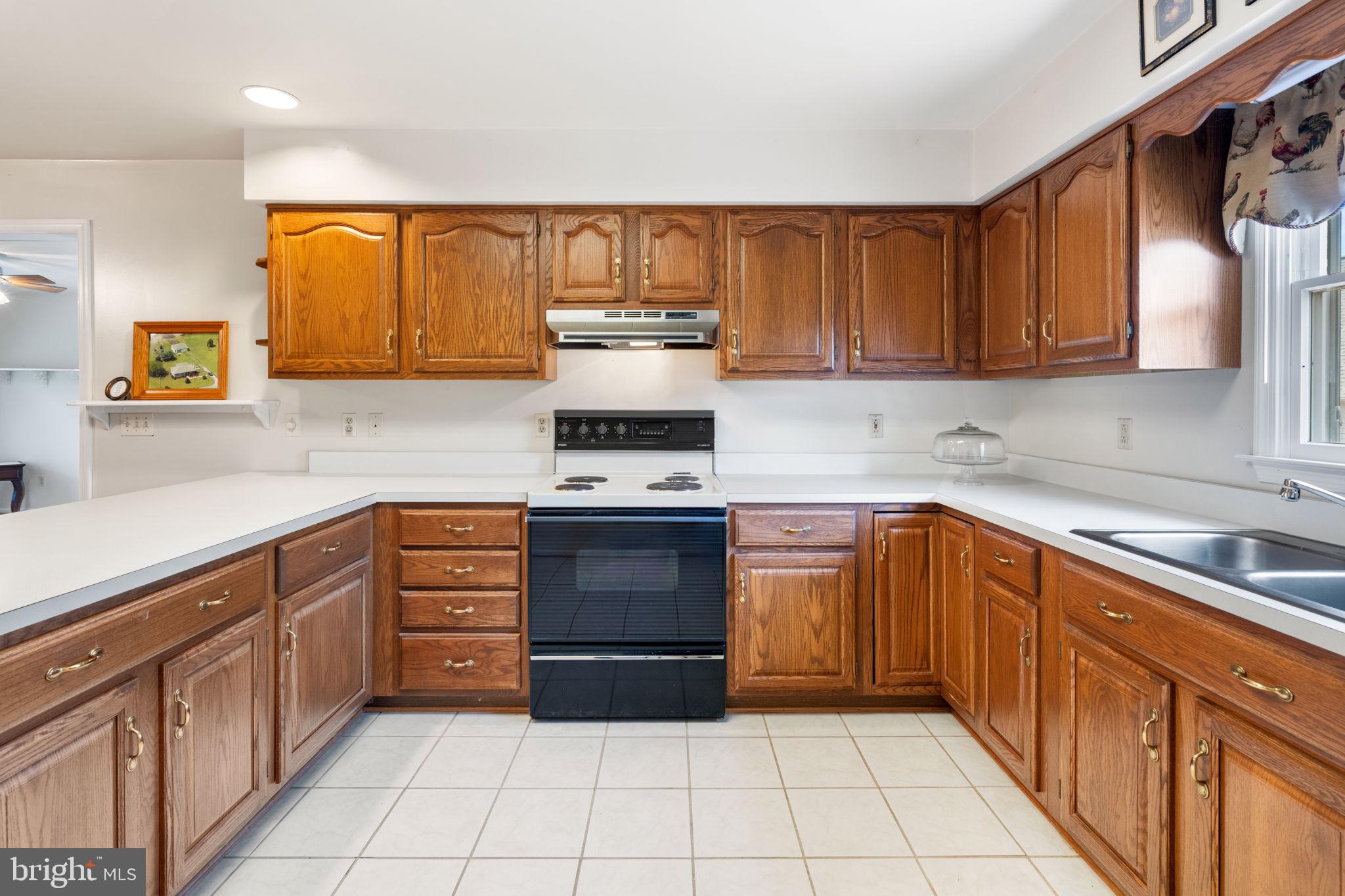 161 Troy Road Louisa, VA 23093 - Photo 7 of 60 a kitchen with stainless steel appliances a stove sink and cabinets