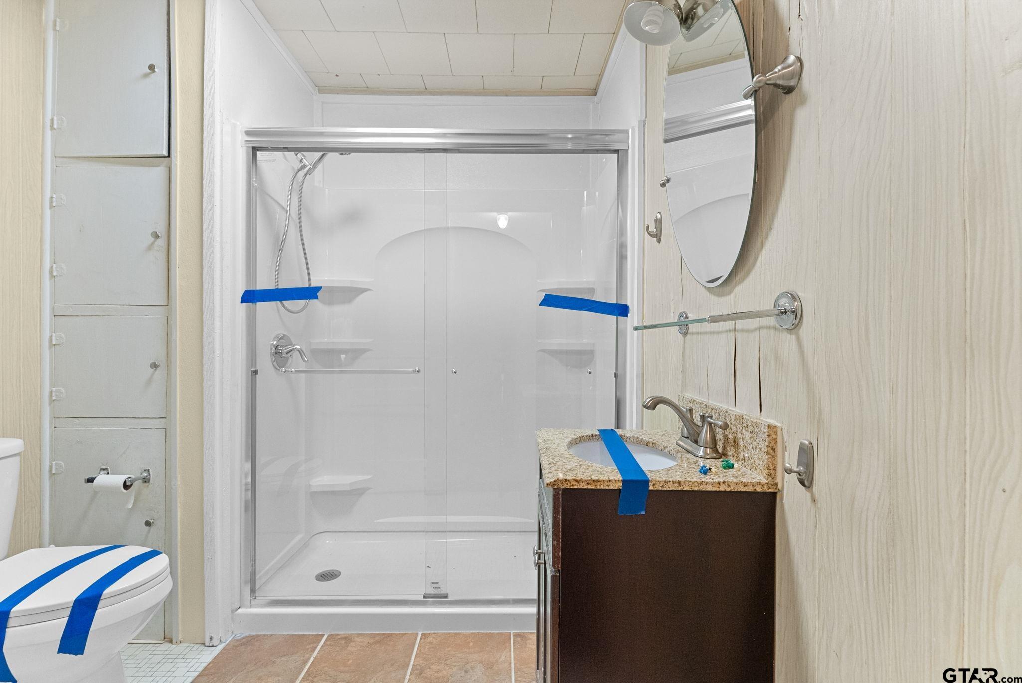 3819 Old Chandler Road Tyler, TX 75702 - Photo 12 of 30 a bathroom with a shower and a sink