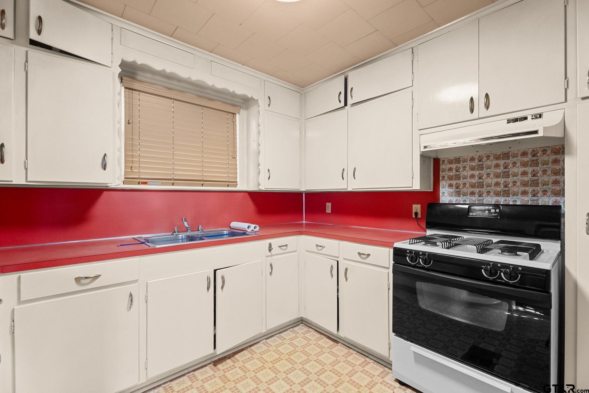 3819 Old Chandler Road Tyler, TX 75702 - Photo 20 of 30 a kitchen with a stove and a microwave