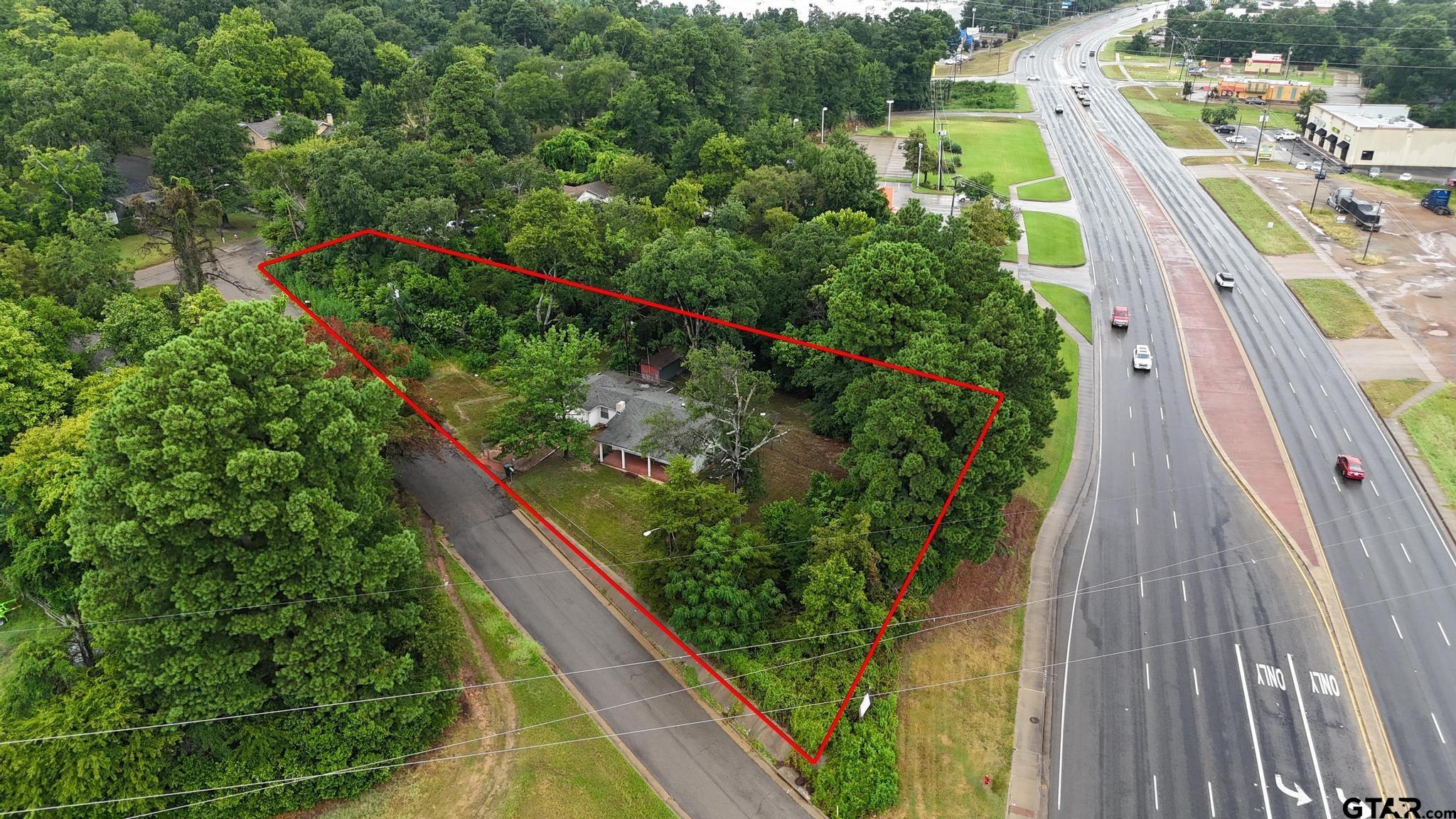 3819 Old Chandler Road Tyler, TX 75702 - Photo 21 of 30 a view of a yard with potted plants