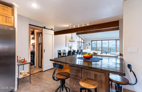 a view of a room that has a table and chairs in it