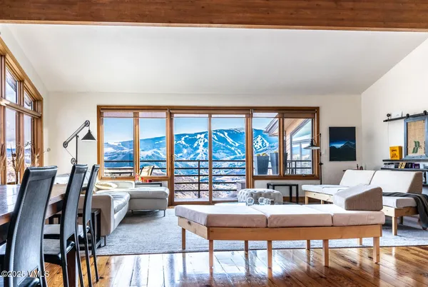 a living room with fireplace furniture and a large window
