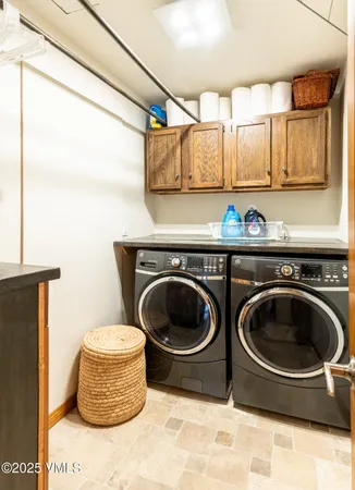 a utility room with sink dryer and washer