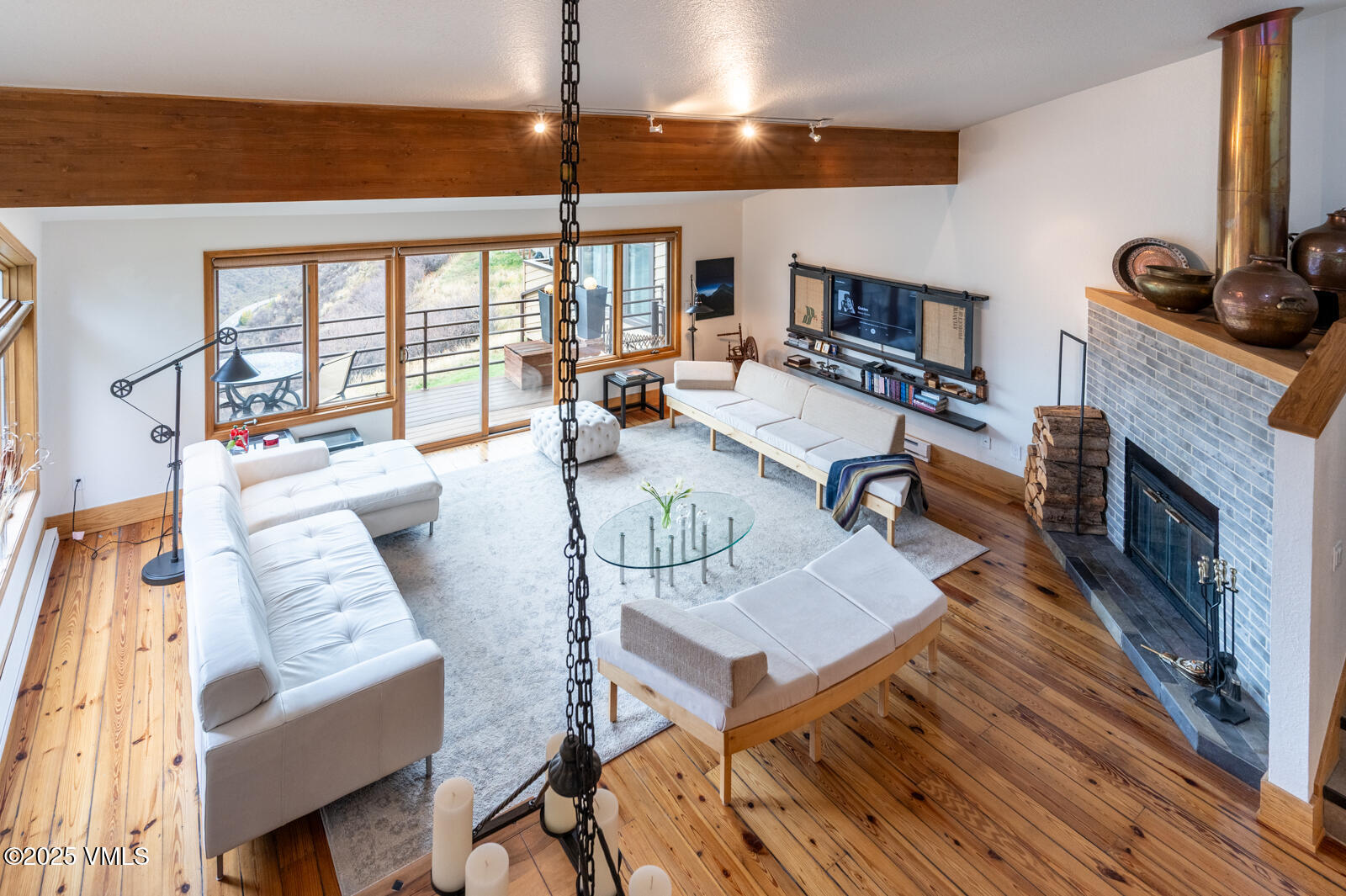 3016 Wildridge Road, Unit 6 Avon, CO 81620 - Photo 4 of 38 a living room with furniture a flat screen tv and a fireplace