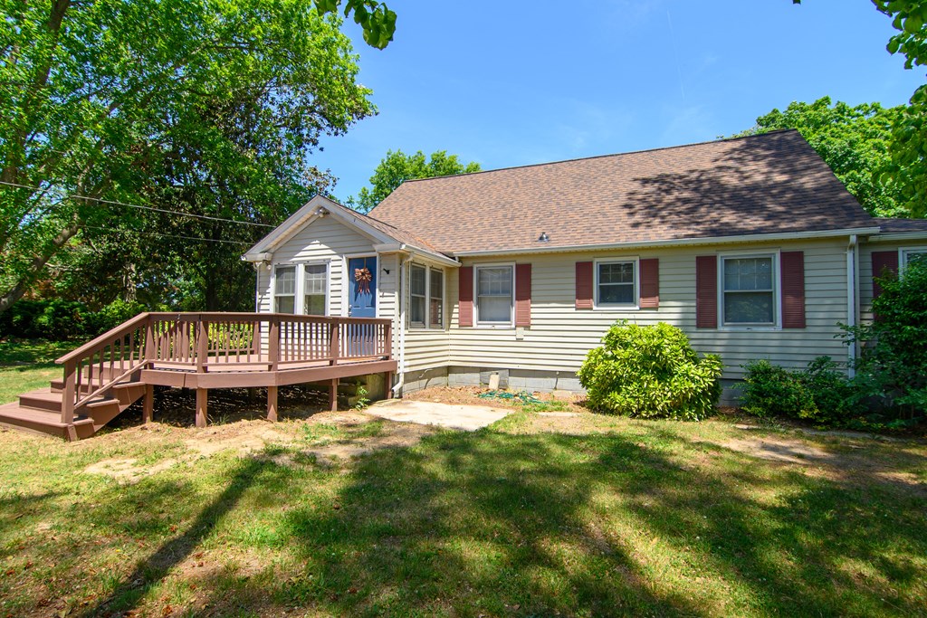 24432 Maxwell Street Parksley, VA 23421 - Photo 4 of 39 a front view of a house with a yard table and chairs