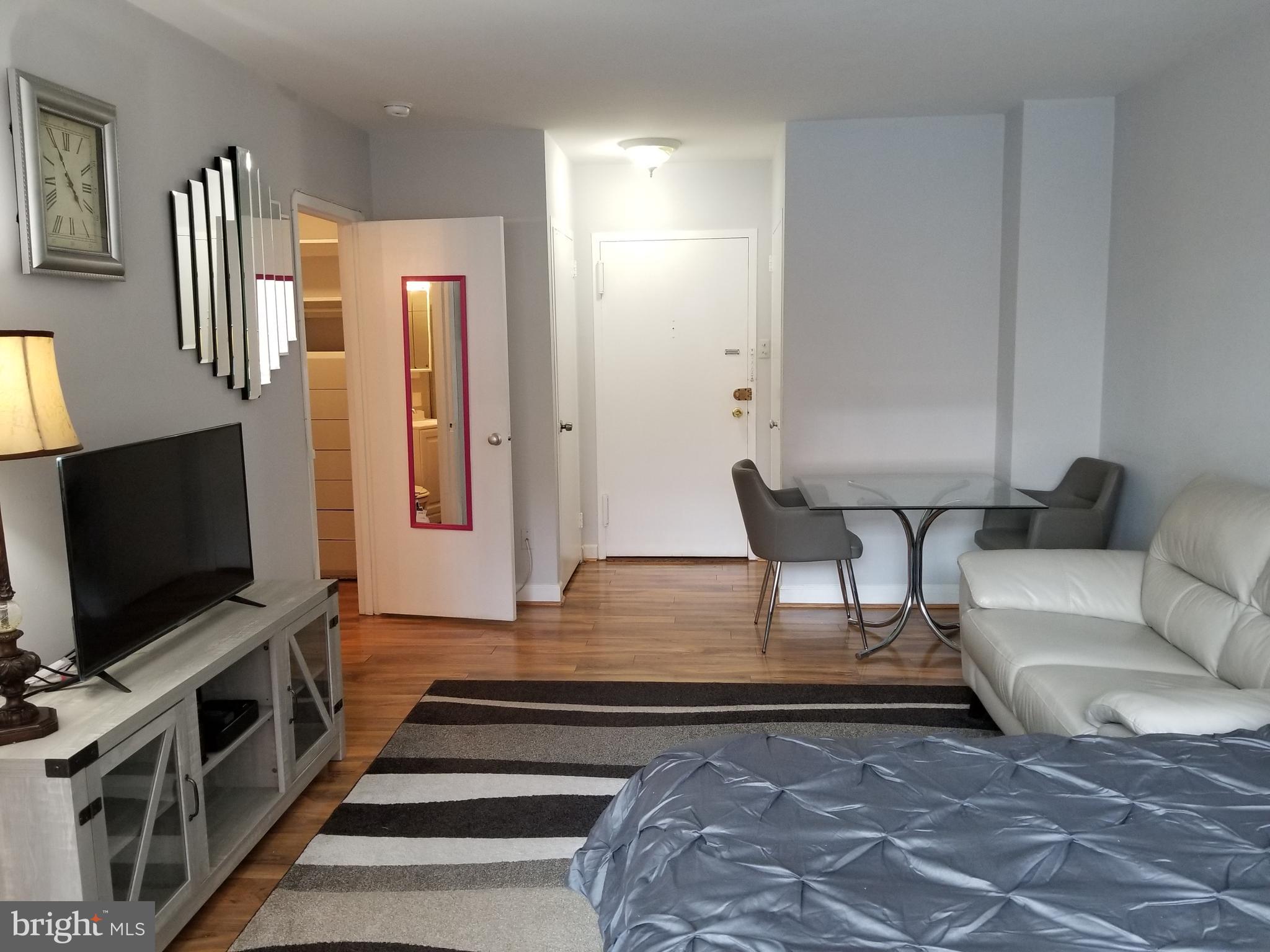 1021 Arlington Boulevard, Unit 414 Arlington, VA 22209 - Photo 1 of 31 a living room with furniture and a flat screen tv