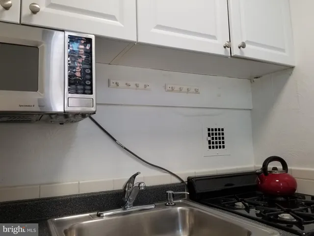 a close view of sink a faucet and a stove
