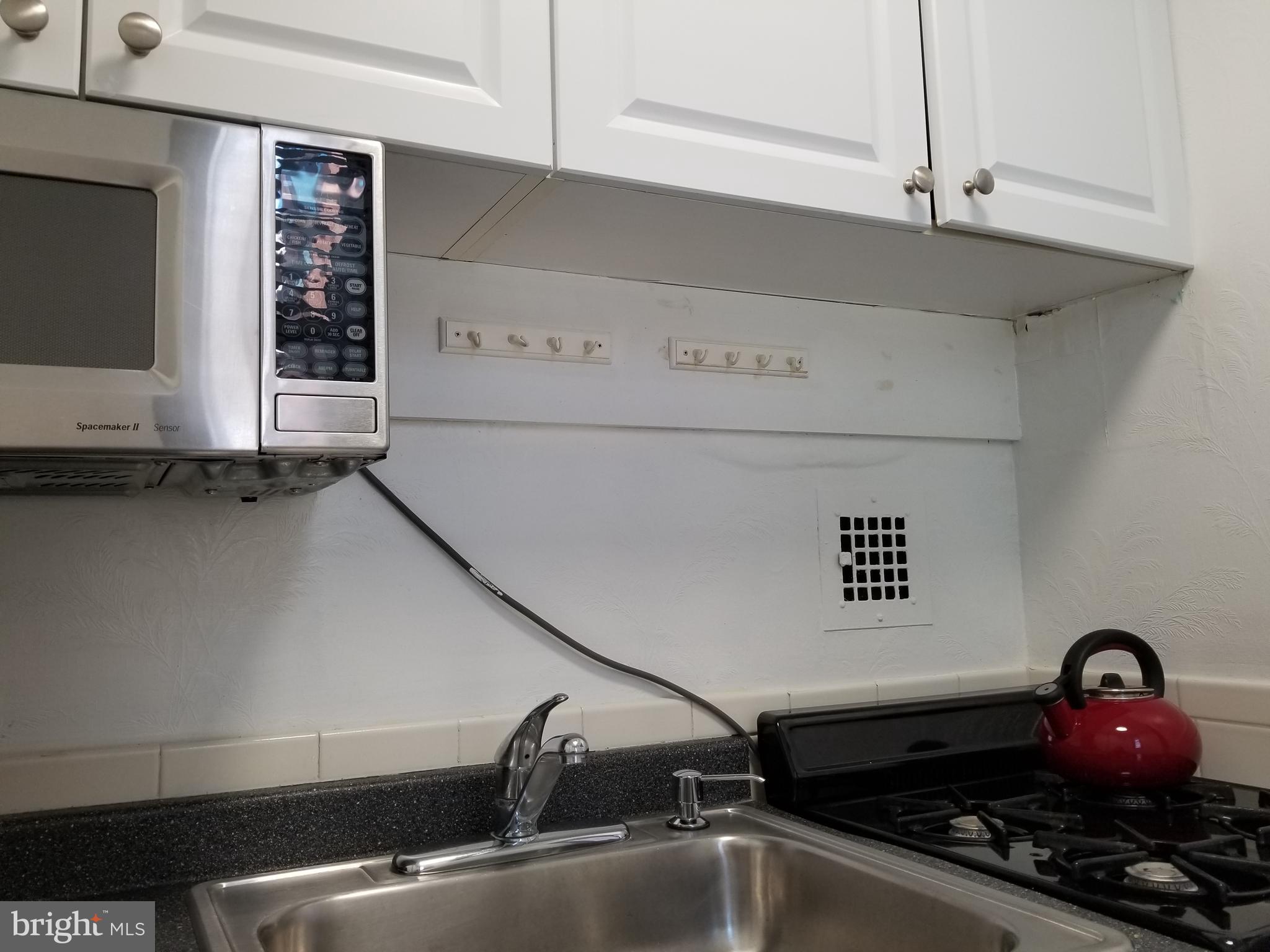 1021 Arlington Boulevard, Unit 414 Arlington, VA 22209 - Photo 13 of 31 a close view of sink a faucet and a stove
