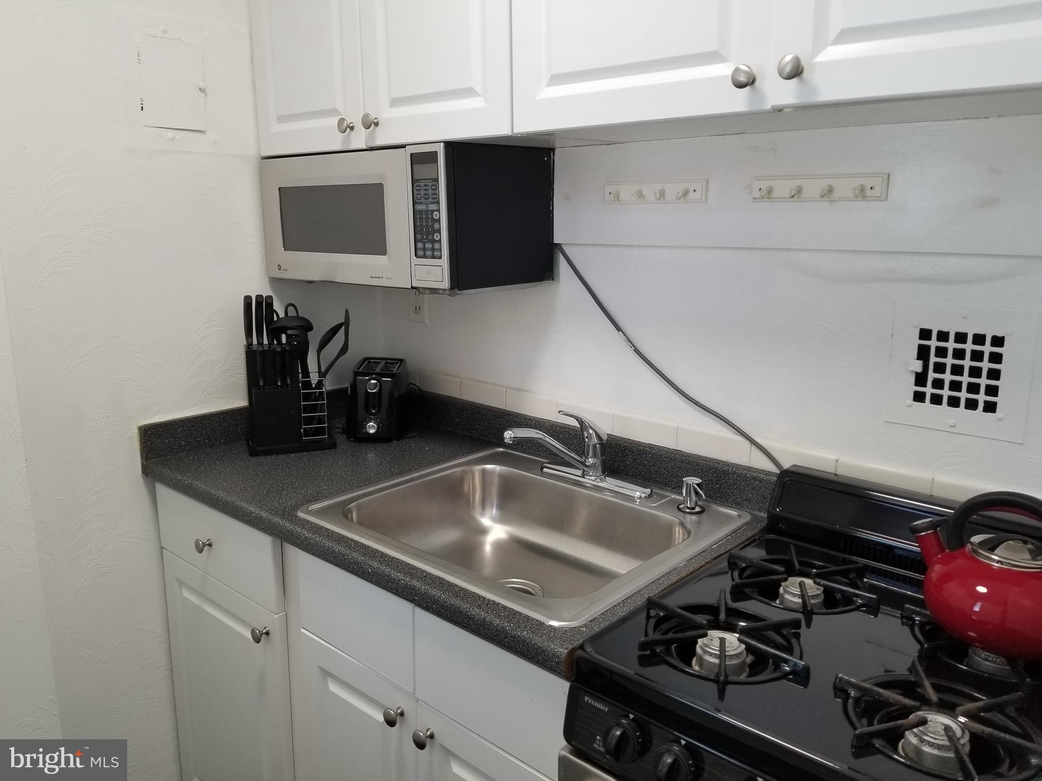 1021 Arlington Boulevard, Unit 414 Arlington, VA 22209 - Photo 14 of 31 a kitchen with a sink appliances and cabinets
