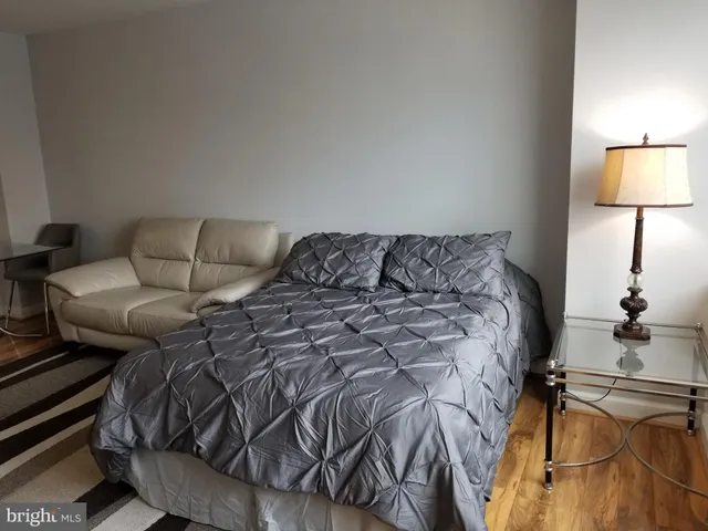 a bed sitting in a bedroom next to a lamp